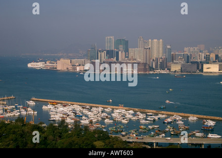 dh Typhoon shelter CAUSEWAY BAY HONG KONG Boats victoria harbour and Tsim Sha Tsui peninsular highrise skyscrapers Stock Photo