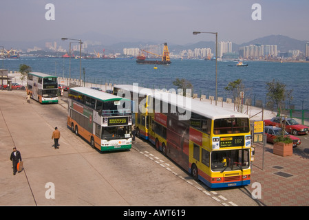 dh Bus Terminal SHEUNG WAN HONG KONG Macau Ferry Pier Citybus and First bus parked waiting stance transport double deck buses Stock Photo