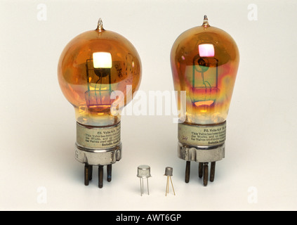 early thermionic valves or vacuum tubes beside  single transistors Stock Photo
