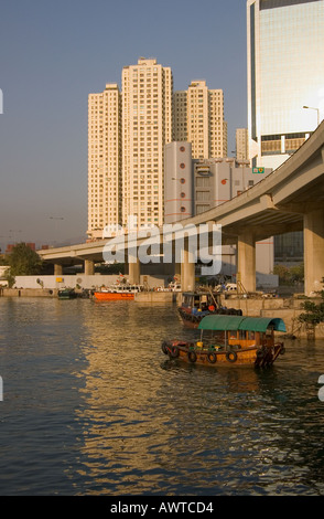 dh Typhoon shelter CAUSEWAY BAY HONG KONG Junk ferry below Eastern corridor and skyscraper buildings harbour boat Stock Photo