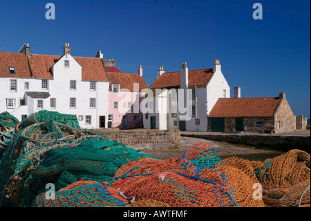 The Gyles, Pittenweem, East Neuk of Fife, Scotland  Fishing nets on the quayside with houses of a style typical to the area Stock Photo