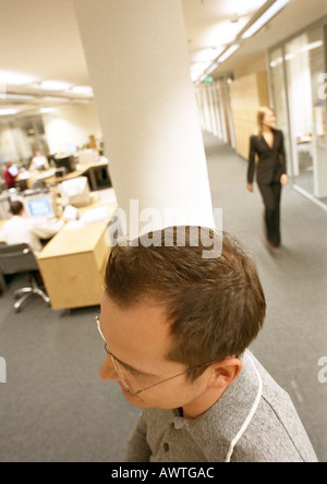 Businessman walking through office, view from above. Stock Photo