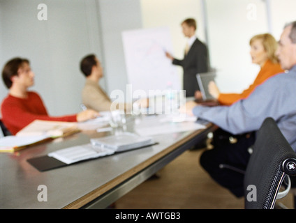 Business people sitting at table in meeting, blurred. Stock Photo