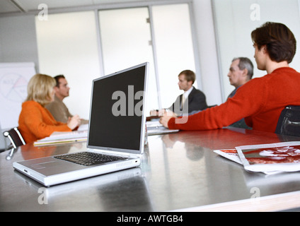 Business people sitting at table in meeting room. Stock Photo