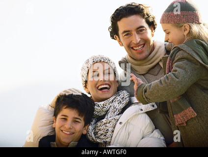 Adult man and woman with two children, smiling, warmly dressed,  oustside, portrait Stock Photo