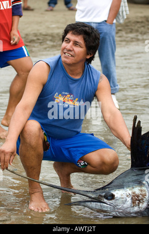 head of swordfish freshly caught with fisherman Puerto Lopez fishing Harbour Ecuador South America Stock Photo