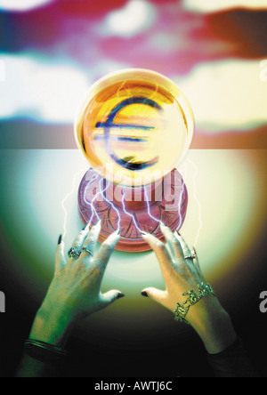 Euro sign materializing in crystal ball. Stock Photo