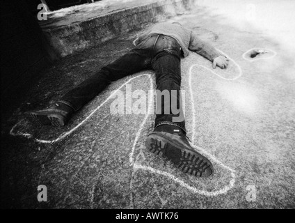 Outline around man lying on ground, b&w Stock Photo