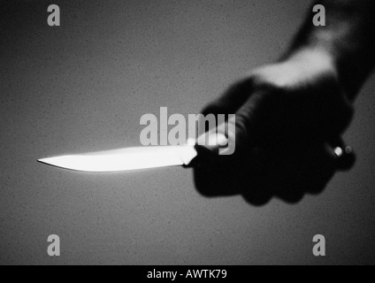 Hand holding knife, close-up, b&w Stock Photo