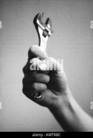 Hand holding wrench, close-up, b&w Stock Photo