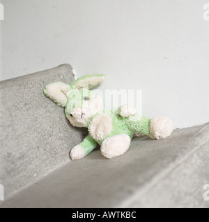 Stuffed rabbit sitting on step Stock Photo