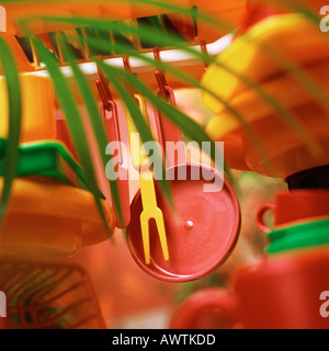 Plastic kitchenware hanging from shelf Stock Photo