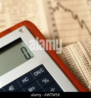 Calculator on top of financial charts Stock Photo