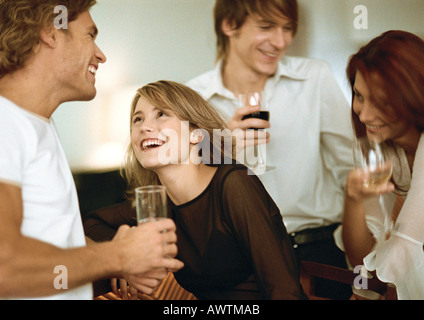 Young men and women drinking at bar Stock Photo