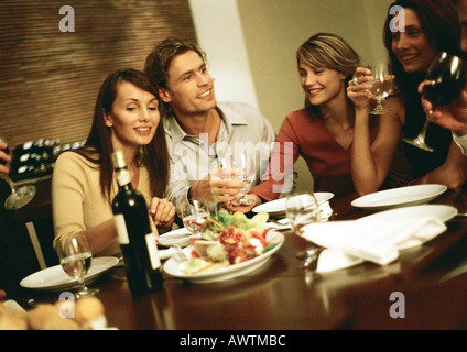 Group of young people around table, drinking Stock Photo