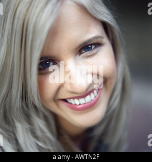 Woman looking at camera, smiling, portrait Stock Photo