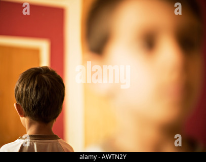 Face with back of head reflected in a mirror Stock Photo