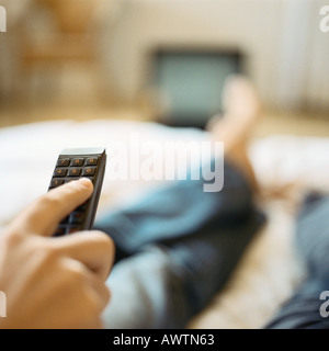 Person using remote control, cropped view Stock Photo