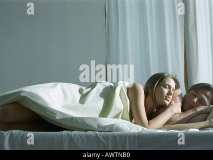 Couple sleeping together in bed Stock Photo