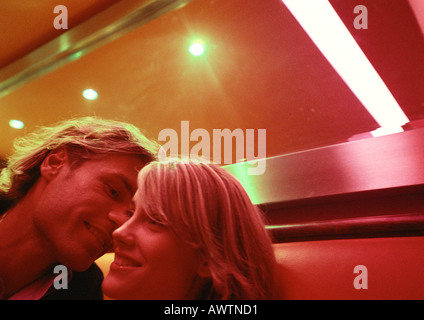 Man leaning to kiss woman's cheek Stock Photo