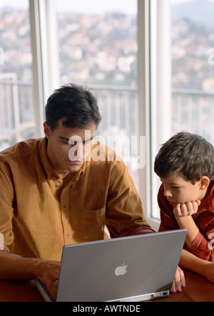 Father and son working on computer. Stock Photo