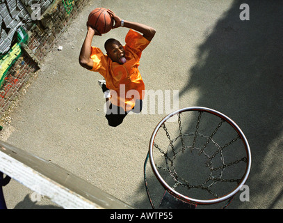Man going up for a basketball dunk, shot from above