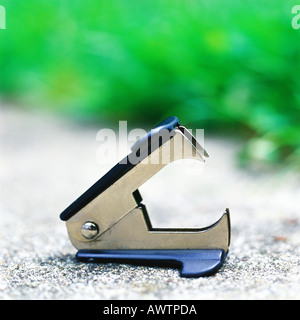 Staple remover on sidewalk Stock Photo