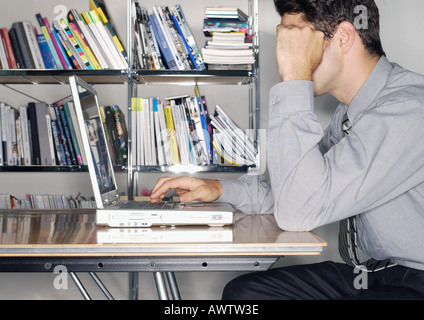 Man using laptop, side view Stock Photo