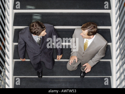 Two businessmen going down stairs, elevated view Stock Photo