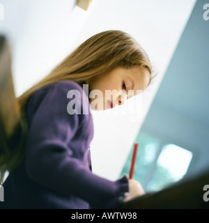 Girl writing, low angle view Stock Photo