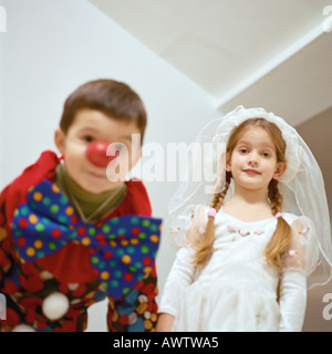 Girl and boy in costumes, low angle view Stock Photo