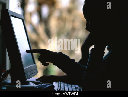 Children using computer, silhouette Stock Photo