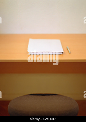 Pen and paper in folder on desk Stock Photo