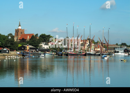 Riverside landscape blue sky day & moorings at Hythe Quay with masts of old historical Thames barges on tidal River Blackwater Maldon Essex England UK Stock Photo