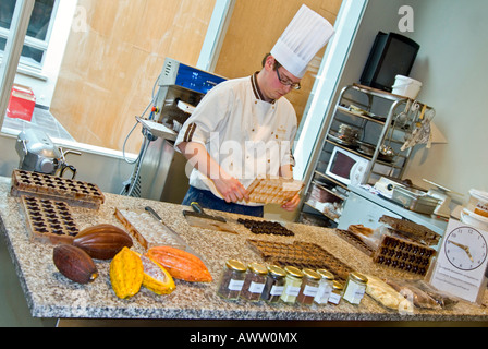 Horizontal wide angle of a demonstration by a chocolatier making handmade chocolates in the chocolate museum in Bruges. Stock Photo