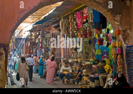 Horizontal wide angle of one of the busy alleyways within the traditional dark dusty souks of Marrakesh. Stock Photo