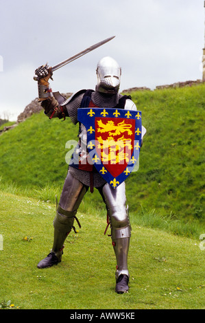 Medieval Knight in Plate Armour sword shield re enactment history costume historical coat of arms three 3 lions lion English UK Stock Photo Alamy