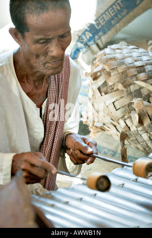 Musician playing roneat at Bakong Monastery, Angkor, Cambodia Stock Photo