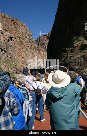 Passengers on train ride through Royal Gorge, Colorado, USA beneath worlds highest suspension bridge. Stock Photo