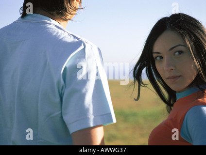 Young woman outdoors with friend, looking at camera, close up Stock Photo