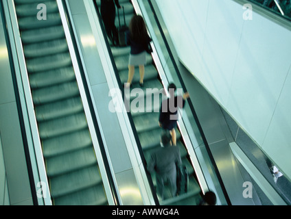 Business people on escalator going up, blurred, high angle view Stock Photo