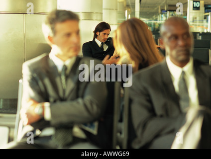 Group of business people sitting together in airport lounge Stock Photo