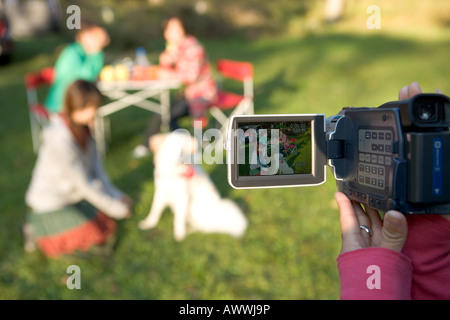 Teenage girl using home video camera, holding, filming Stock Photo