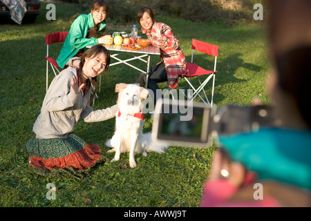 Teenage girl using home video camera, posing, waving Stock Photo