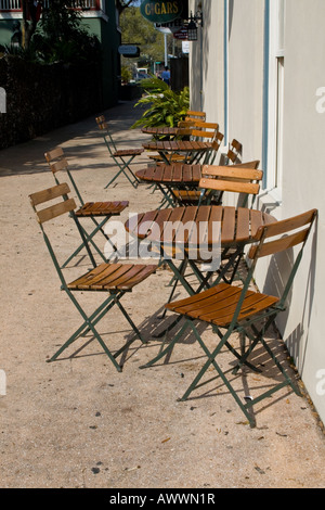 Row of wooden tables and chairs outside a restaurant in St. Augustine, Florida Stock Photo