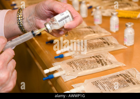 Nurse Preparing IV Medication For Patient Asembly Line Stock Photo