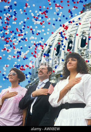 Composite image of four people at a citizenship ceremony superimposed over the U.S. Capitol and balloons Stock Photo
