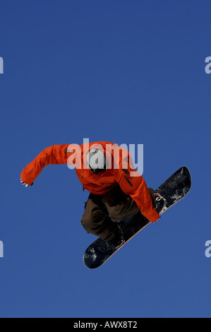 snowboarder springing against blue sky Stock Photo