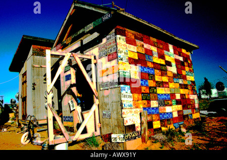 Digitally altered image of old wooden building covered with license plates