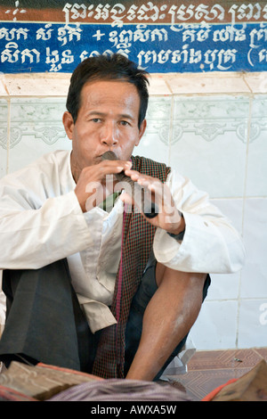 Musician playing sralai at Bakong Monastery, Angkor, Cambodia Stock Photo